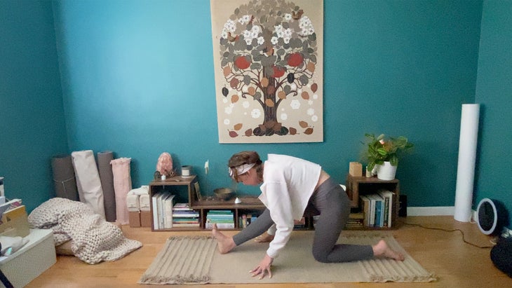 woman practicing a half split yoga pose on a mat