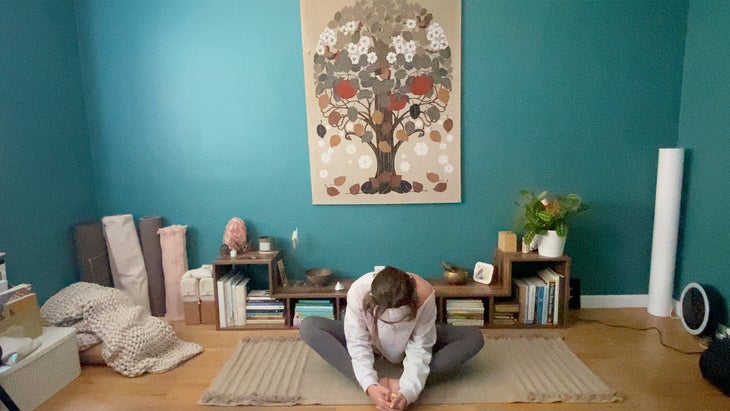 woman practicing a yoga pose on a mat