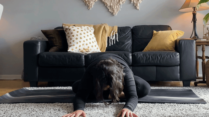 Woman sitting cross-legged and leaning forward