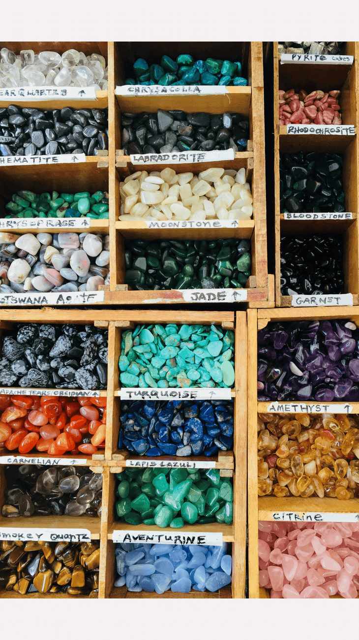 A container with different compartments filled with different types of crystals.