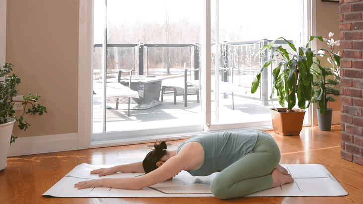 Yoga With Kassandra practicing Child's Pose during a 20-minute morning yoga practice