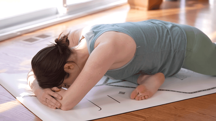 Yoga with Kassandra practicing Pigeon Pose on a yoga mat