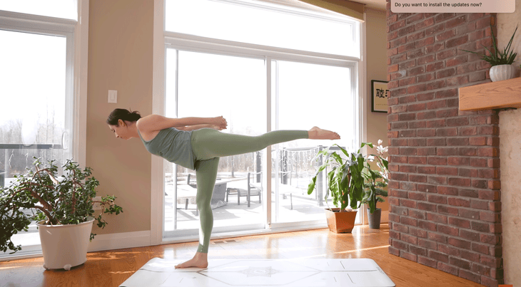 Woman practicing the standing balancing pose Warrior 3 during a 20-minute yoga practice