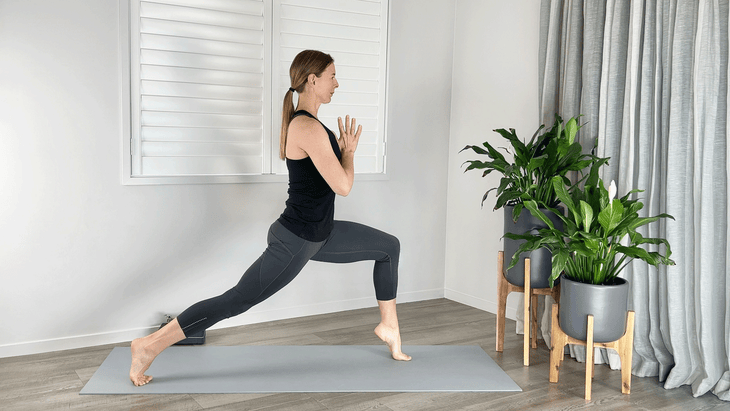 Woman in a high lunge with her front heel lifted