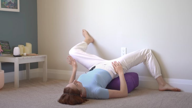 woman practicing yoga with her legs up a wall in different directions