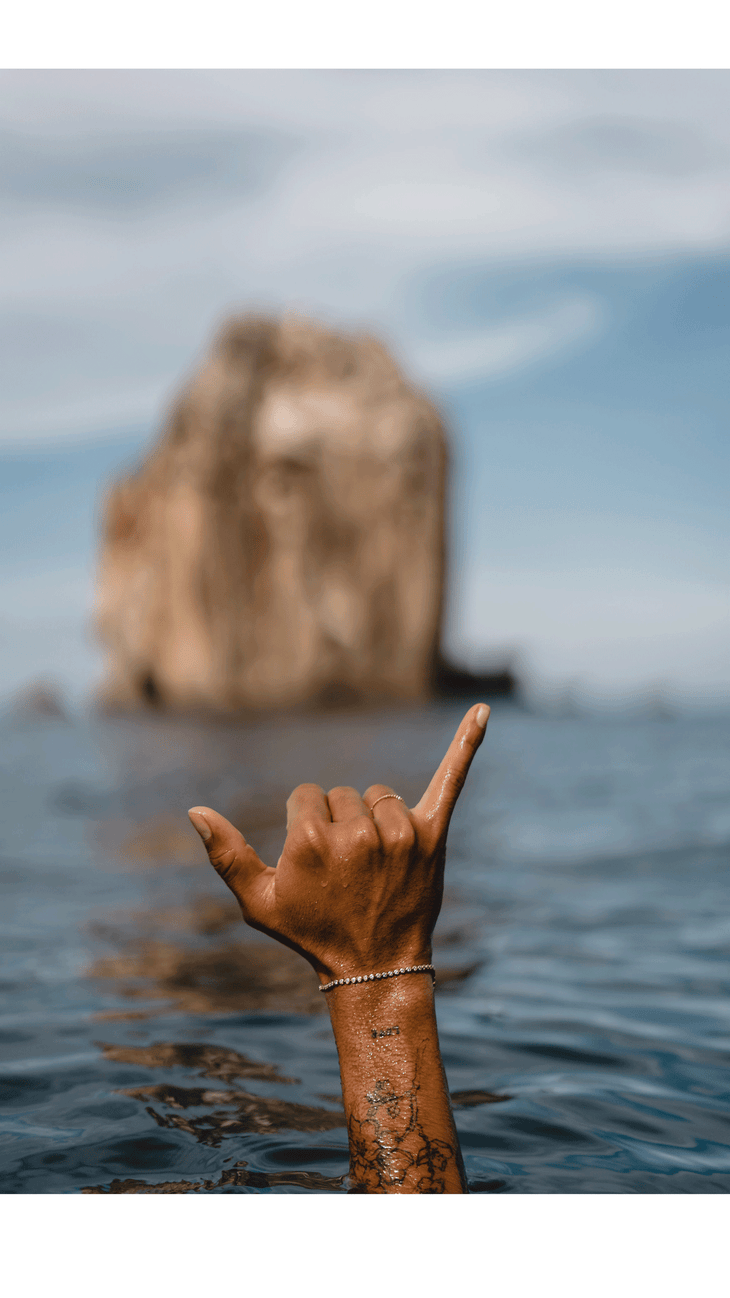 Surfer putting their fist above the water