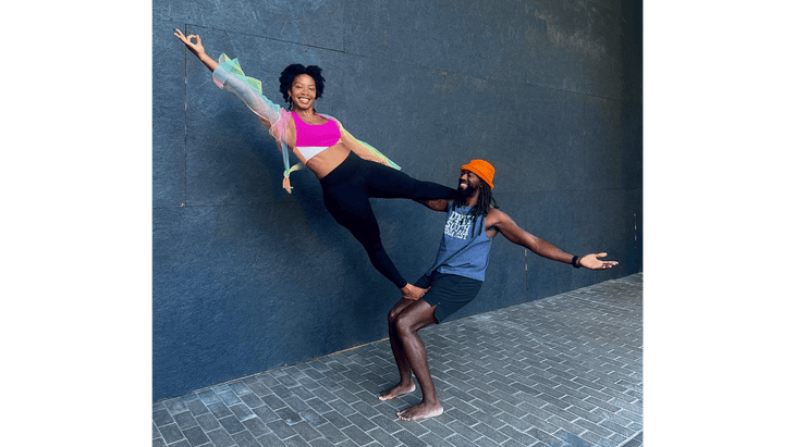 Couple of people at the Dirty South Yoga Fest in Atlanta practicing partner yoga