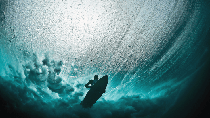 Surfer during the Paris Olympics 2024 on his board practicing Cobra Pose