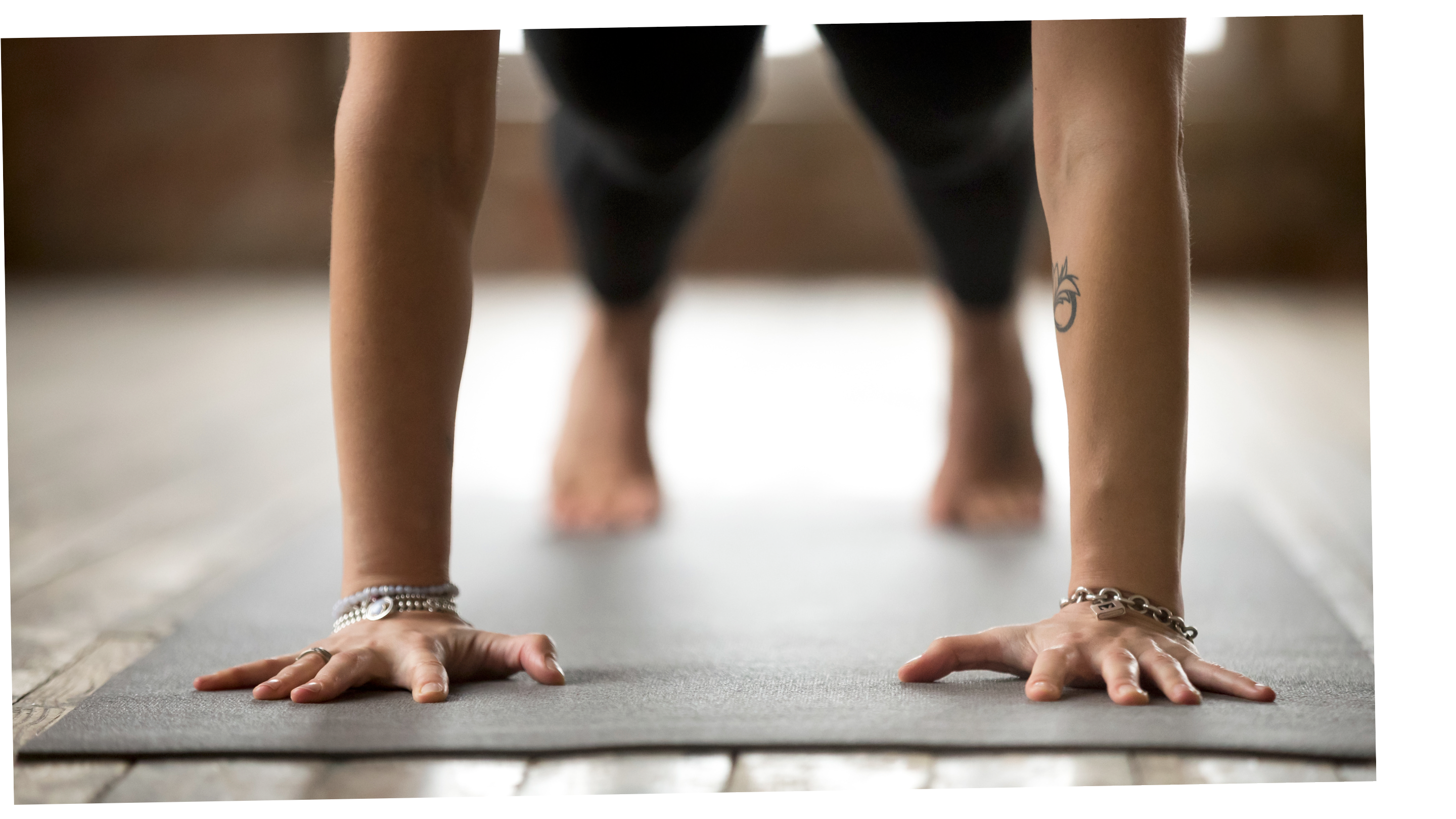 Woman yoga student practicing Plank Pose on a yoga mat