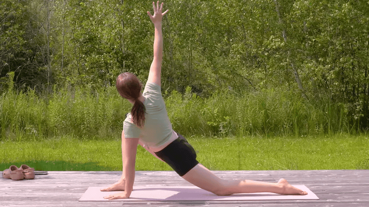 Woman practicing a Low Lunge in yoga with a twist to the right