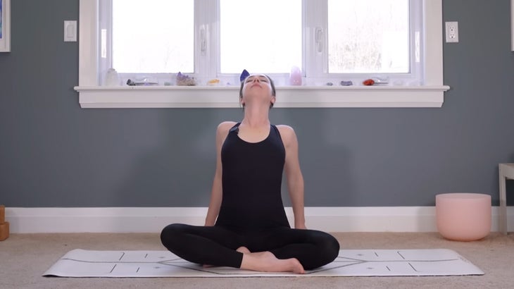 woman on a yoga mat does a morning practice