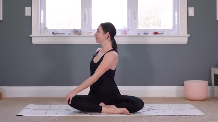 woman on a yoga mat does a morning practice