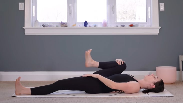 woman on a yoga mat does a morning practice