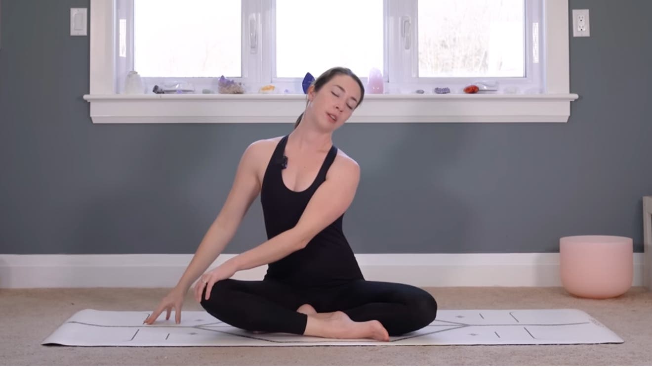 woman on a yoga mat does a morning practice