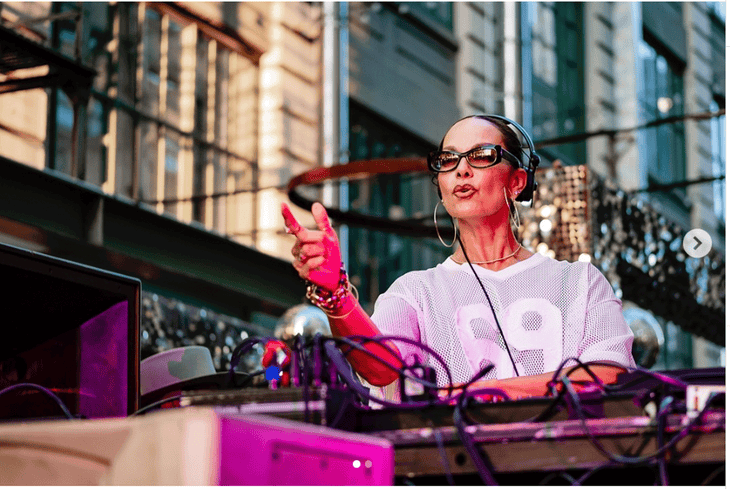 DJ Anané Vega at an outdoor afternoon concert in a city