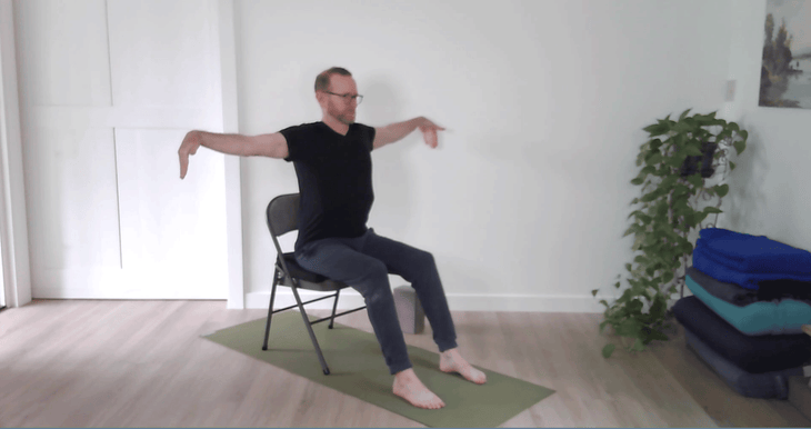 Man in a chair practicing yoga