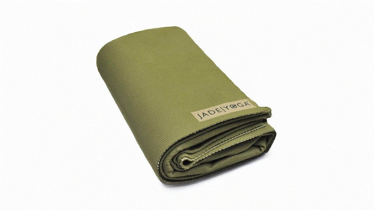 jade green travel yoga mat folded into a tight rectangle