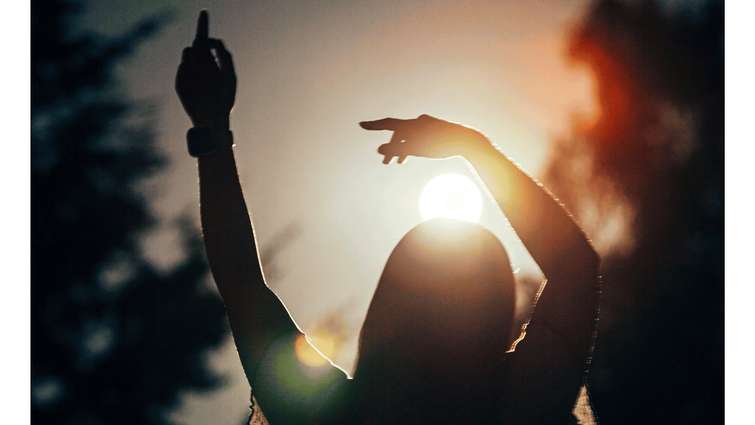 Silhouette of a woman standing outside as the Sun lowers as she contemplates her weekly horoscope for September 14-20, 2025