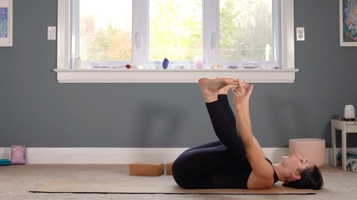 woman does yoga for core strength on a mat