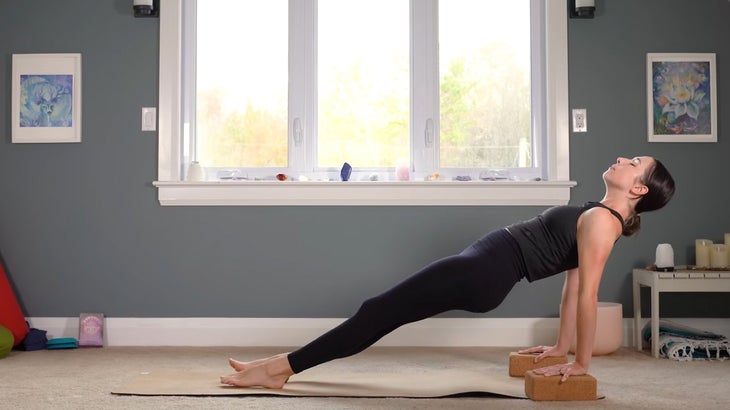 woman does yoga for core strength on a mat