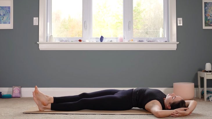 woman does yoga for core strength on a mat