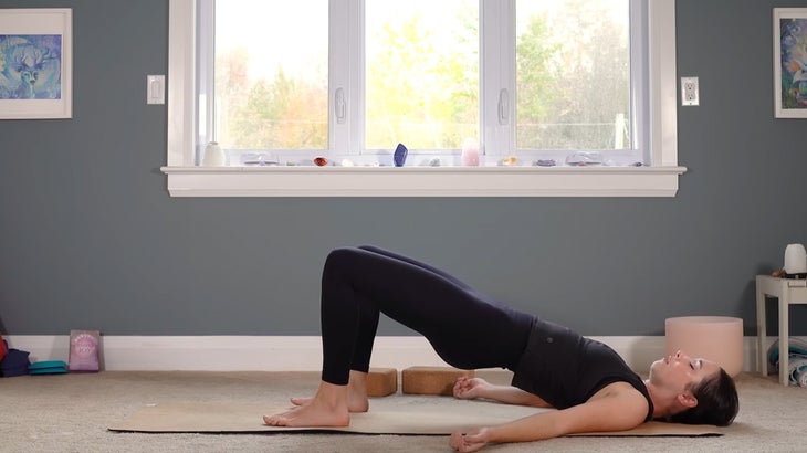 woman does yoga for core strength on a mat