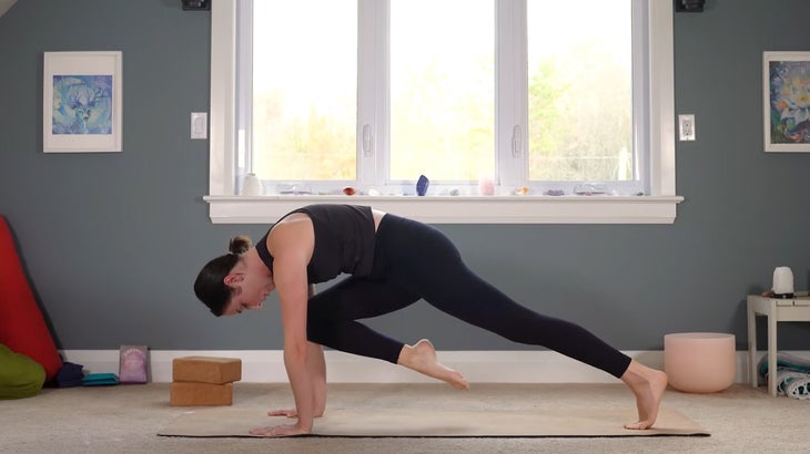 woman does yoga for core strength on a mat