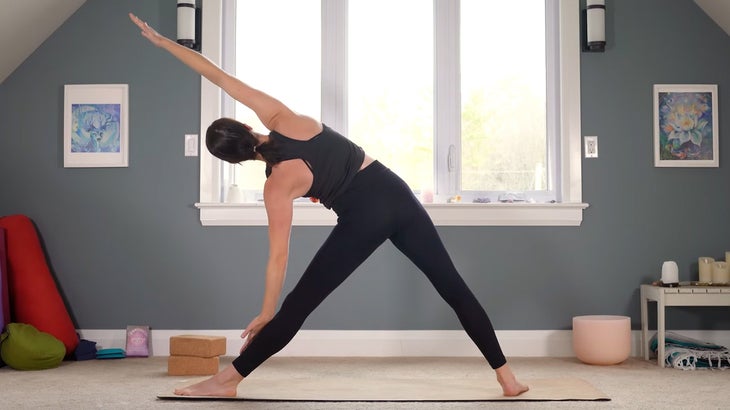 woman does yoga for core strength on a mat