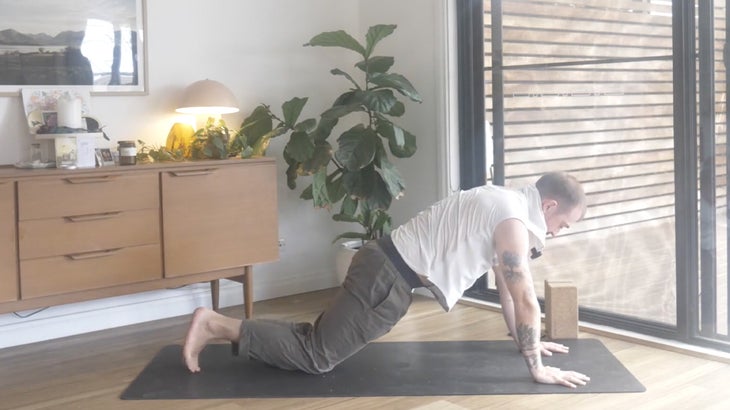 Man strengthening his lower back with yoga poses