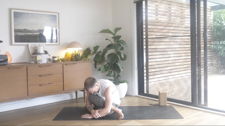 man practicing yoga poses to strengthen his lower back