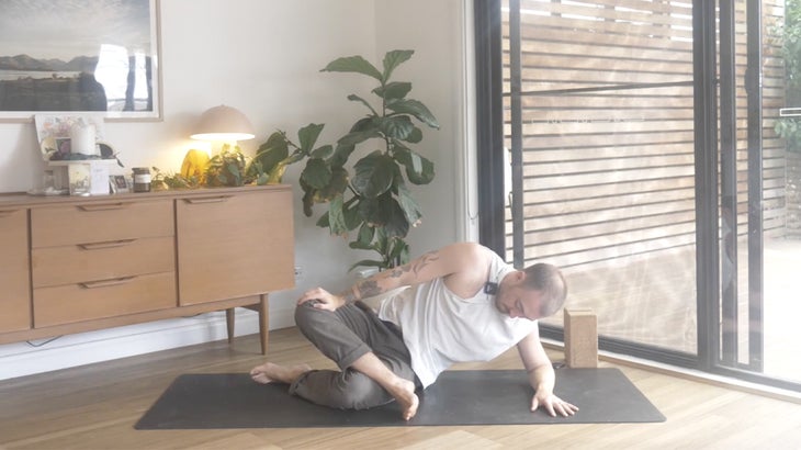 man practicing yoga poses to strengthen his lower back