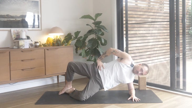 man practicing yoga poses to strengthen his lower back