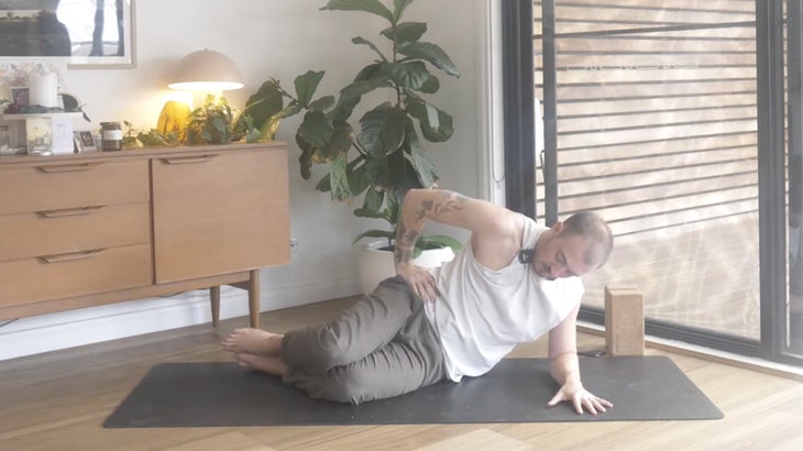 man practicing yoga poses to strengthen his lower back