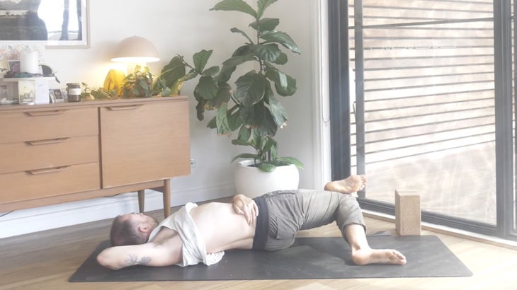 man practicing yoga poses to strengthen his lower back