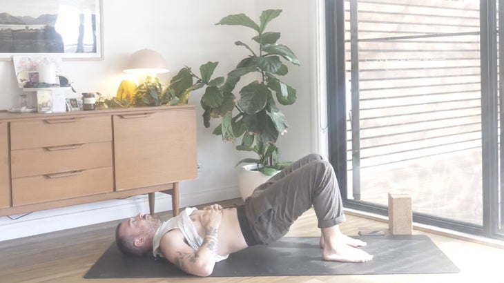 man practicing yoga poses to strengthen his lower back