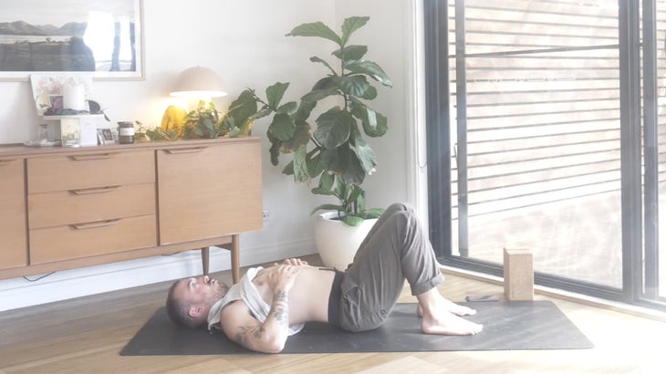 Man strengthening his lower back with yoga poses