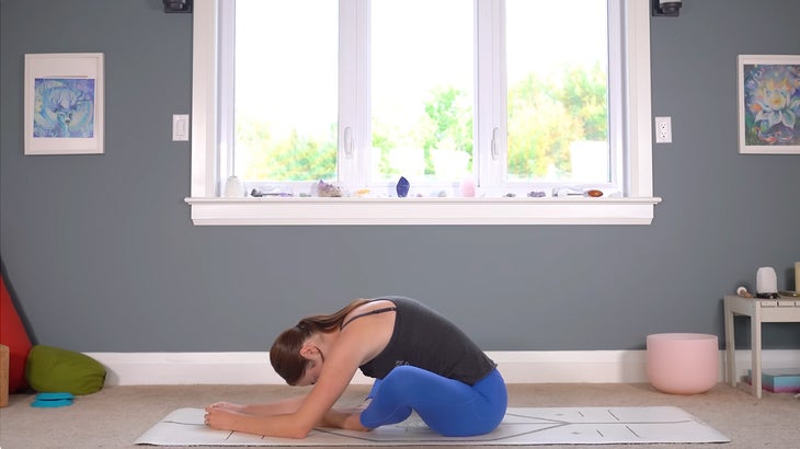 woman practicing gentle yoga poses on a mat