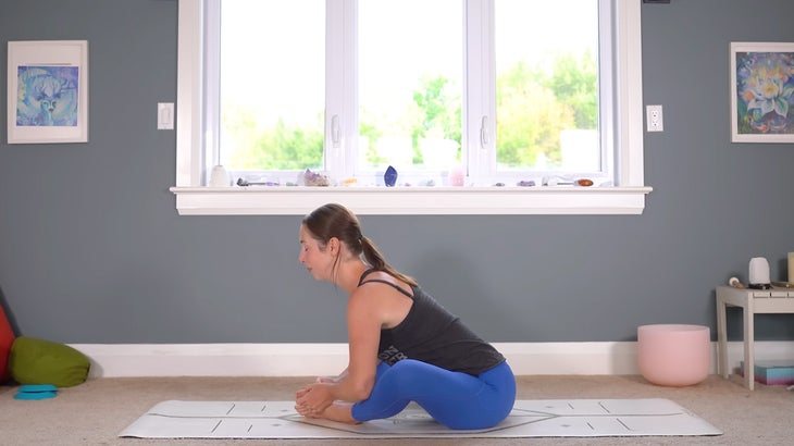 woman practicing a full body stretching routine on a mat