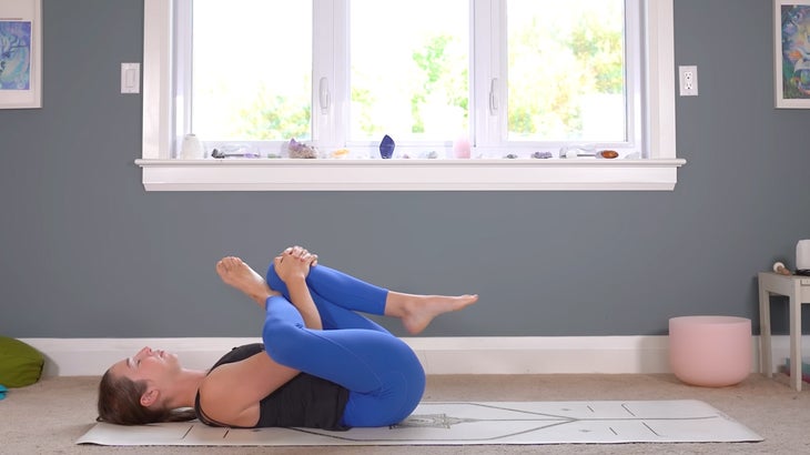 woman practicing gentle yoga poses on a mat