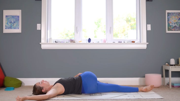 woman practicing a full body stretching routine on a yoga mat