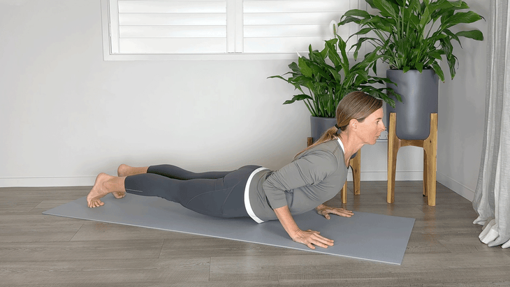 Woman on a yoga mat in Chaturanga with her hips sagging too low