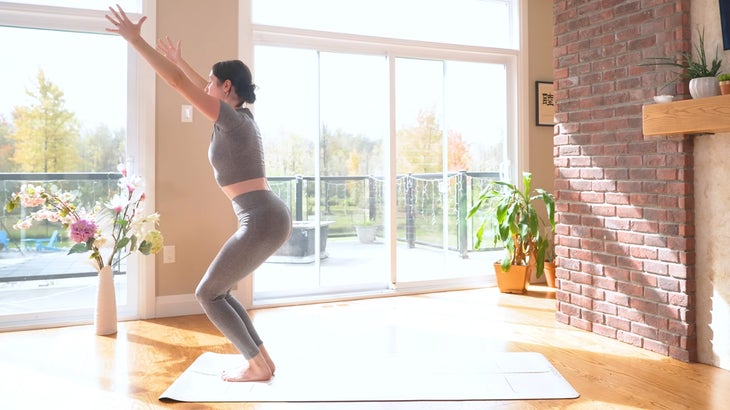 woman practicing a power yoga flow on a mat