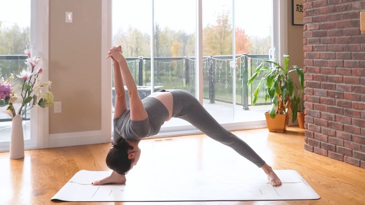 woman practicing a power yoga flow on a mat