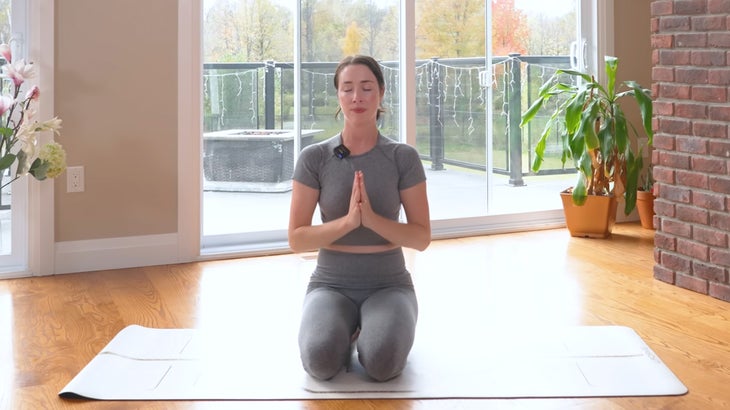 woman practicing a power yoga flow on a mat