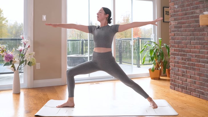 woman practicing a power yoga flow on a mat