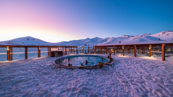 a group of people in a snowy hot tub