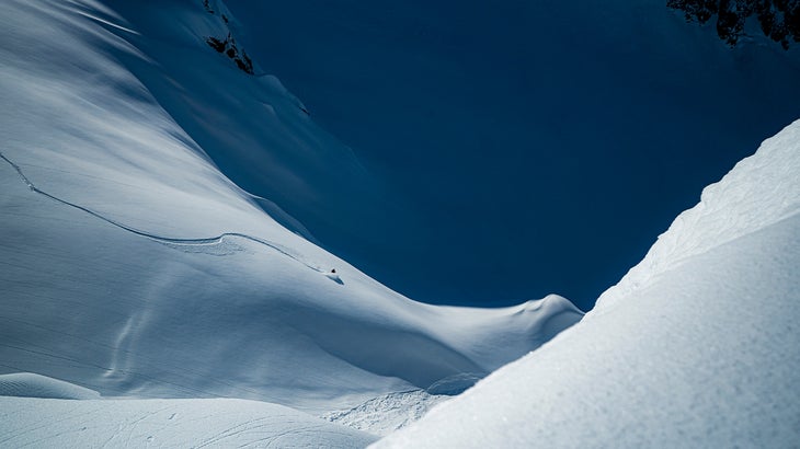 skier going down a snowy mountain