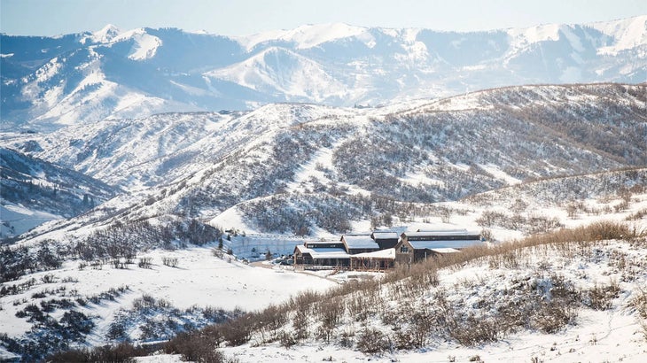 a lodge in a middle of a snowy valley