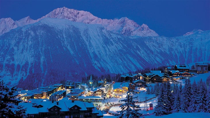 a snowy city at night in the French alps