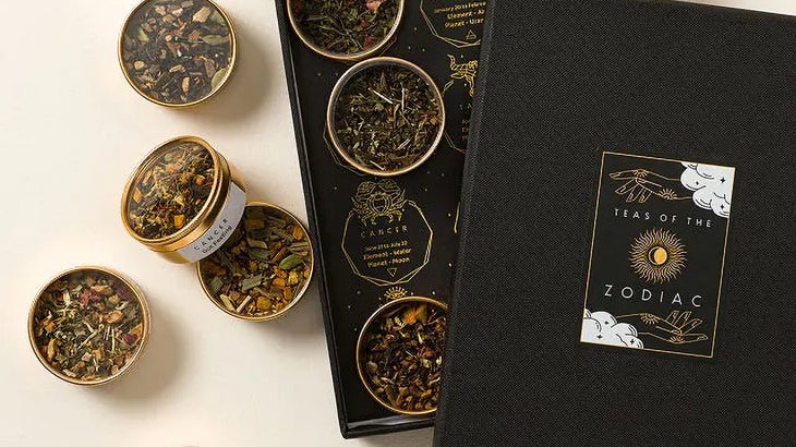 black box of 12 tea blends in small metal tins